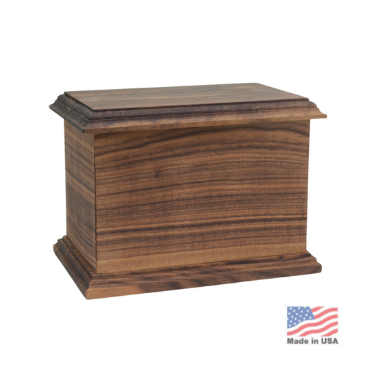 Walnut cremation urn with visible grain, chamfered edges and a low fitted lid