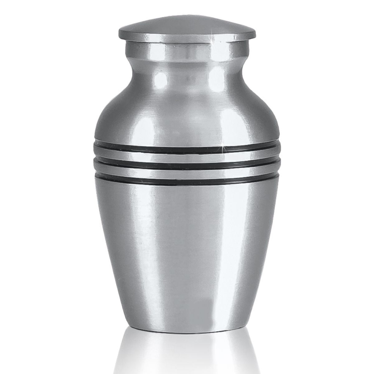 Small brass keepsake urn with a soft grey pewter finish and a rounded lift-off lid