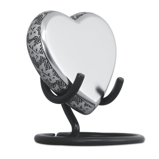 Brass heart keepsake urn with raised maple leaves and veining across the face