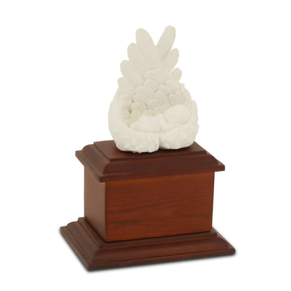 Small infant urn in unpainted wood with a rounded lid and visible grain