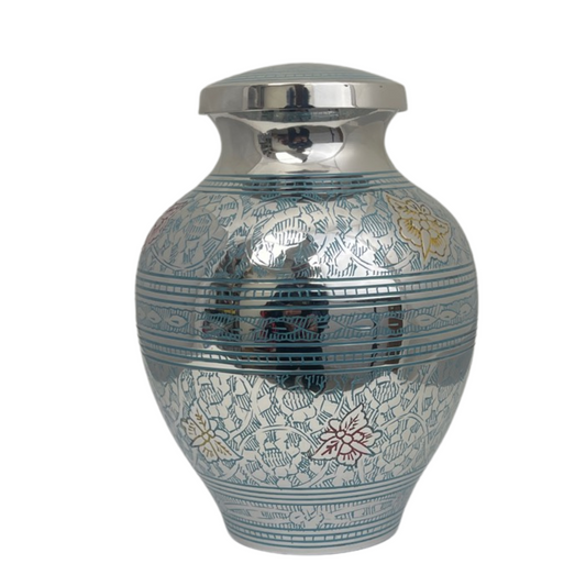Rounded blue brass child urn with pale butterflies across a deep blue painted surface