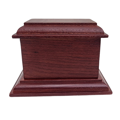 Dark stained wood keepsake urn with visible grain and softly eased corners