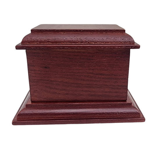 Dark stained wood keepsake urn with visible grain and softly eased corners