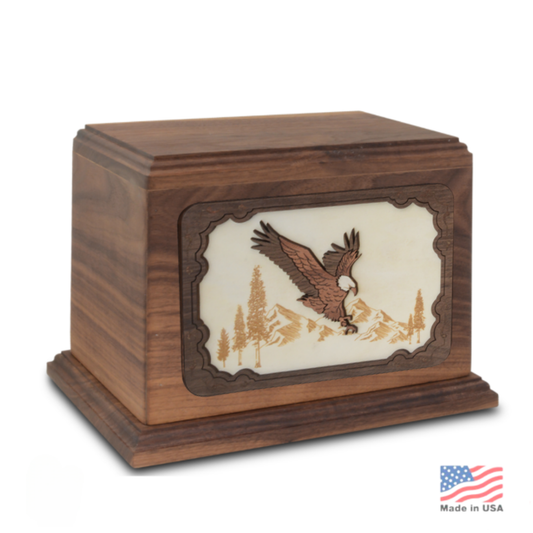 Wood cremation urn with a bald eagle sculpted in relief, wings open, on the front