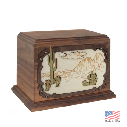 Wood cremation urn carved with a layered desert landscape of rock formations and sky