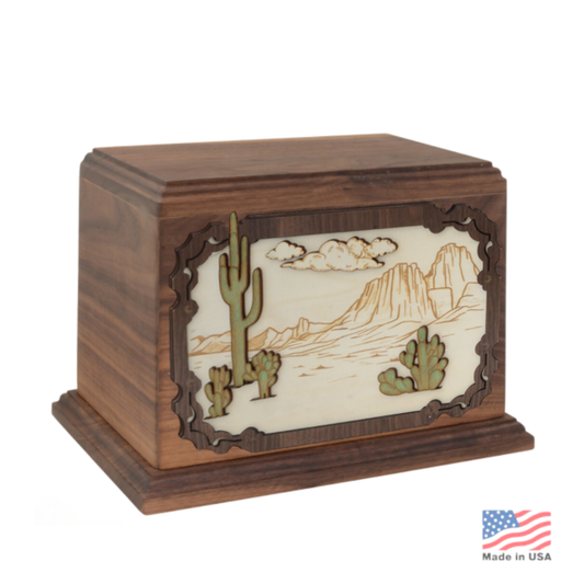 Wood cremation urn carved with a layered desert landscape of rock formations and sky