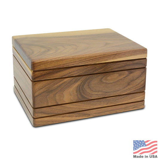 Low wide walnut cremation urn with a smooth plain front and dark grain