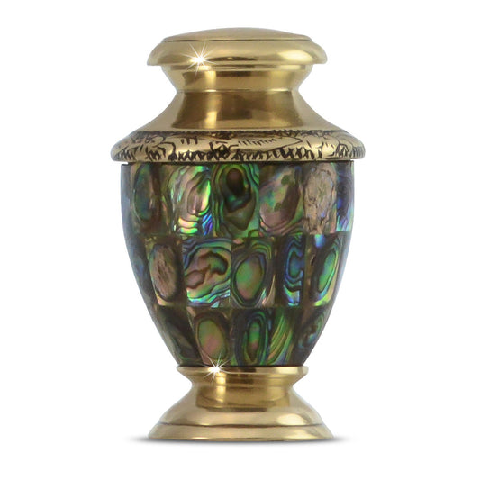 Small brass keepsake urn inlaid with iridescent abalone shell in green and blue tones