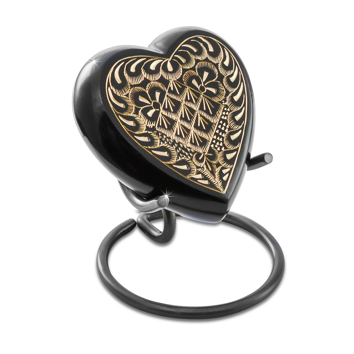 Black heart-shaped brass keepsake urn with fine etched scrollwork across the front panel