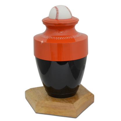 Brass baseball cremation urn finished in orange and black with raised stitching