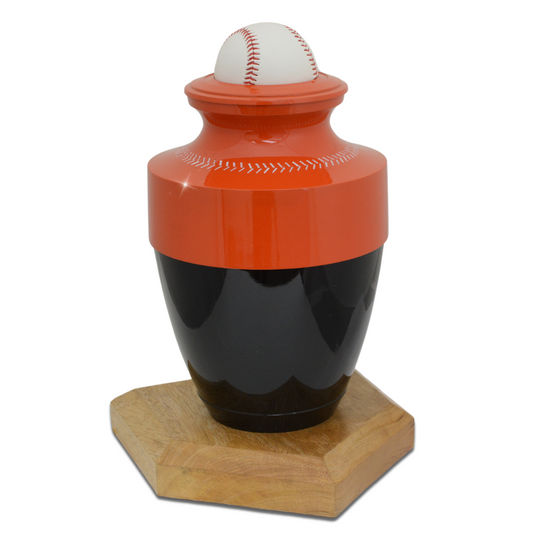 Brass baseball cremation urn finished in orange and black with raised stitching