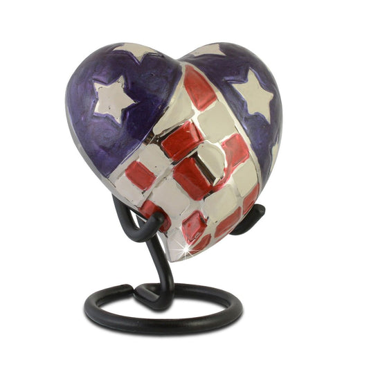 Metal keepsake urn with a heart on the front filled with American flag stars and stripes