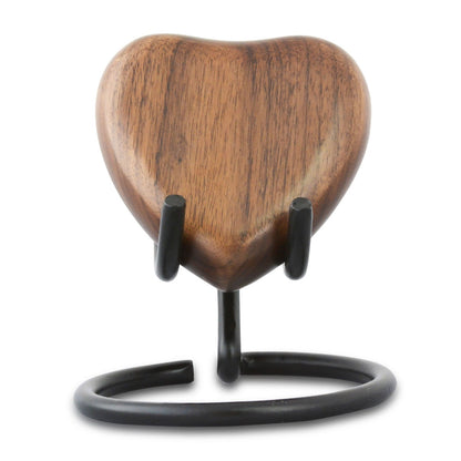 Heart-shaped keepsake urn in dark stained wood with a smooth polished surface