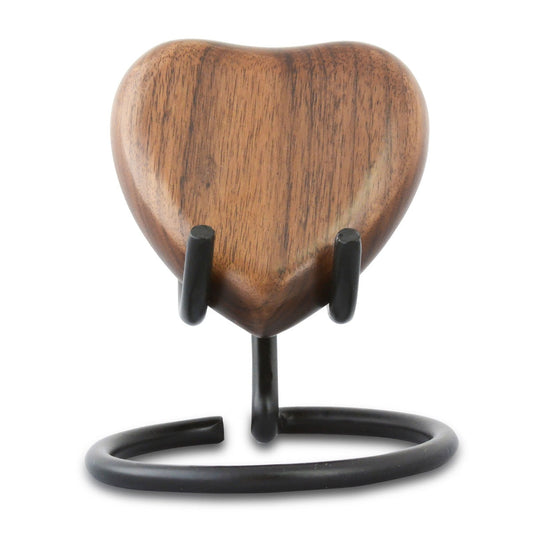 Heart-shaped keepsake urn in dark stained wood with a smooth polished surface