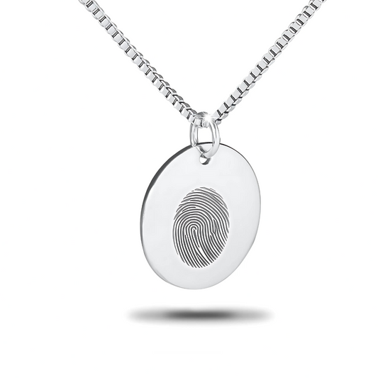 Plain round silver disc pendant, unmarked on the front, hanging from a chain