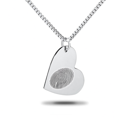 Flat silver heart pendant with a smooth blank surface hanging on a chain