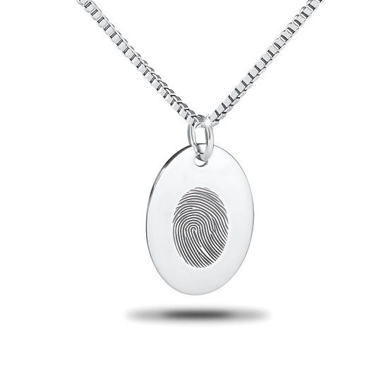 Oval sterling silver pendant with a fingerprint impression across its polished face