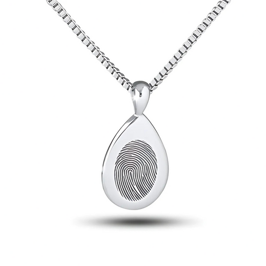 Elongated silver teardrop pendant with a fingerprint impression across its width