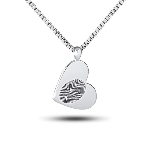 Small rounded silver heart pendant with a fingerprint pattern across the front