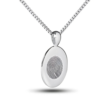 Flat silver oval pendant with an unengraved polished face hanging on a chain