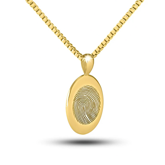 Oval 10K gold cremation pendant with a smooth polished front and a small bail