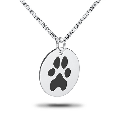 Round stainless steel pendant with an engraved paw print in the center
