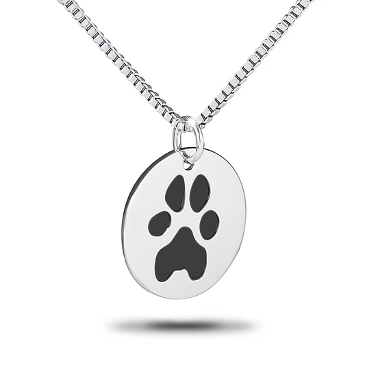 Round stainless steel pendant with an engraved paw print in the center