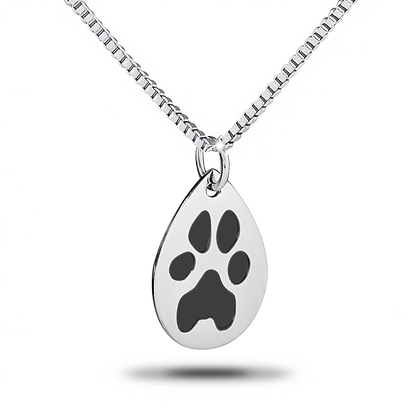 Teardrop-shaped steel pendant with an engraved paw print and a chain loop at the top