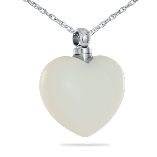 White artisan glass heart pendant on a chain, with swirls suspended inside clear glass