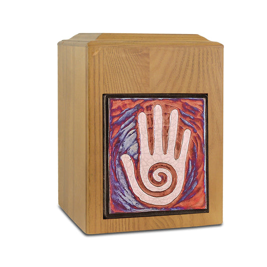 Wooden cremation urn with natural finish and carved hand motif on the front panel