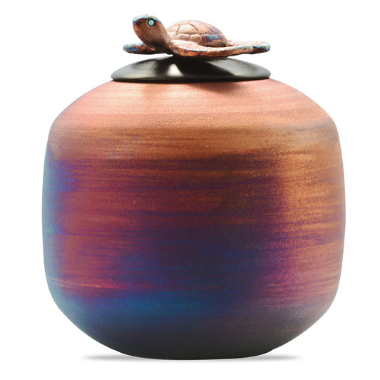 Raku-fired ceramic urn with crackled glaze and a raised turtle motif on the body