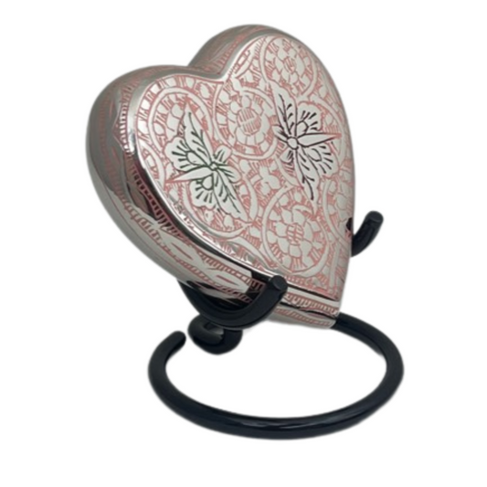 Pink heart keepsake urn on brass with raised butterflies across the front