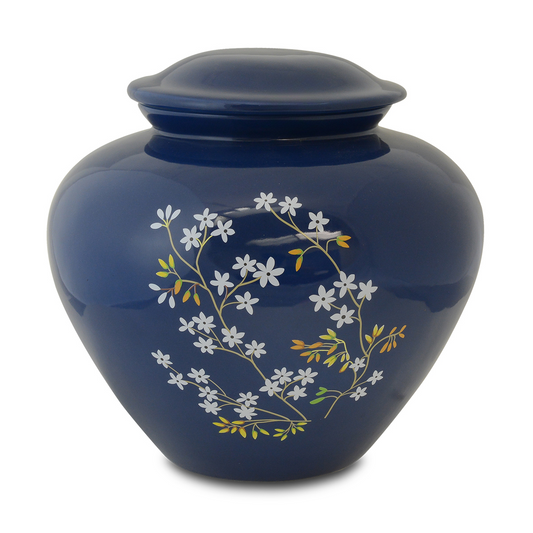 Blue glazed ceramic cremation urn with painted forget-me-not flowers on the shoulder