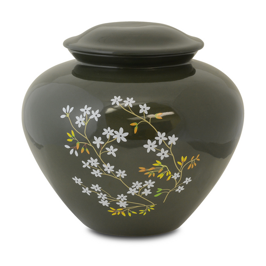 Green glazed ceramic cremation urn with forget-me-not flowers around the shoulder