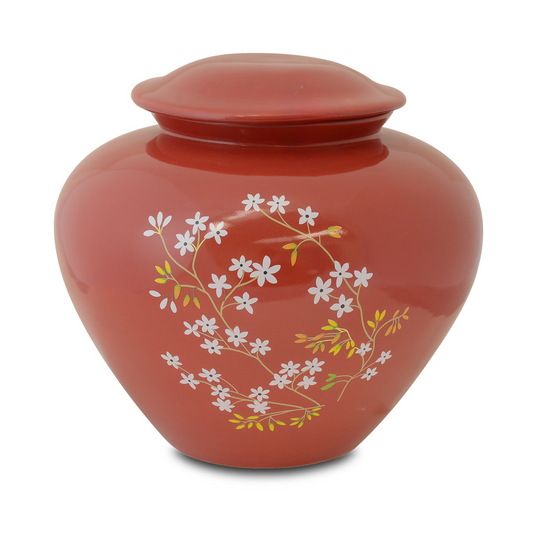 Red glazed ceramic cremation urn with forget-me-not flowers around the shoulder