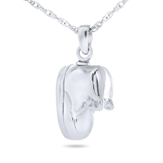 Small silver keepsake shaped like a baby bootie with a threaded opening at the top