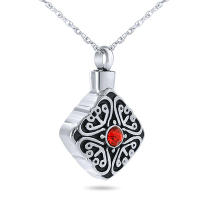 Stainless steel pendant with a faceted deep red crystal ringed by fine metal detailing