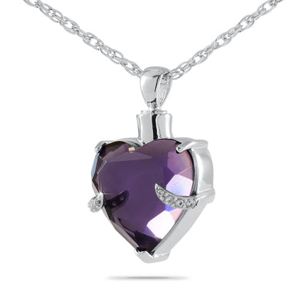 Silver heart pendant with a deep purple face, one inch wide and three-quarters of an inch tall