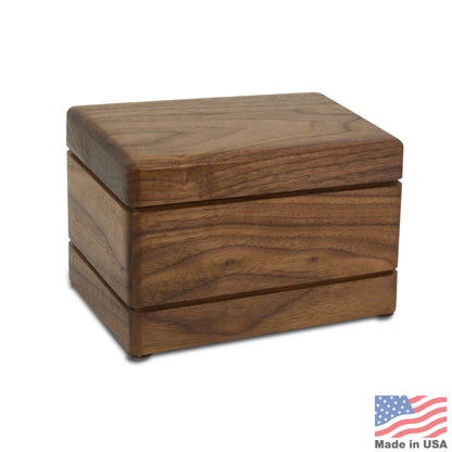 Small rectangular walnut-finish wood pet urn with visible grain and a fitted lid