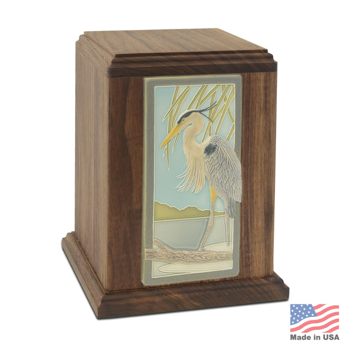 Walnut wood cremation urn with a ceramic tile inlay of a blue heron on the front
