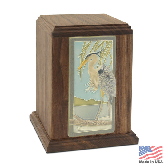 Walnut wood cremation urn with a ceramic tile inlay of a blue heron on the front