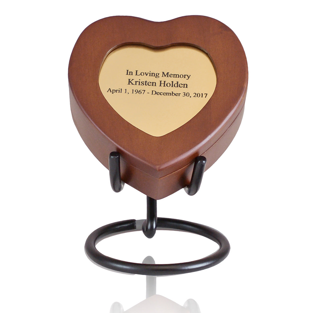 Small open-sided metal display stand for holding a keepsake urn upright
