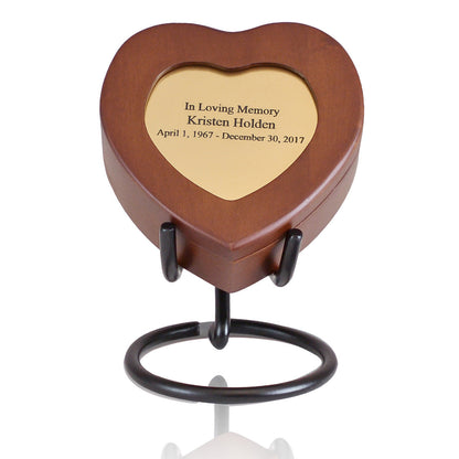 Small open-sided metal display stand for holding a keepsake urn upright