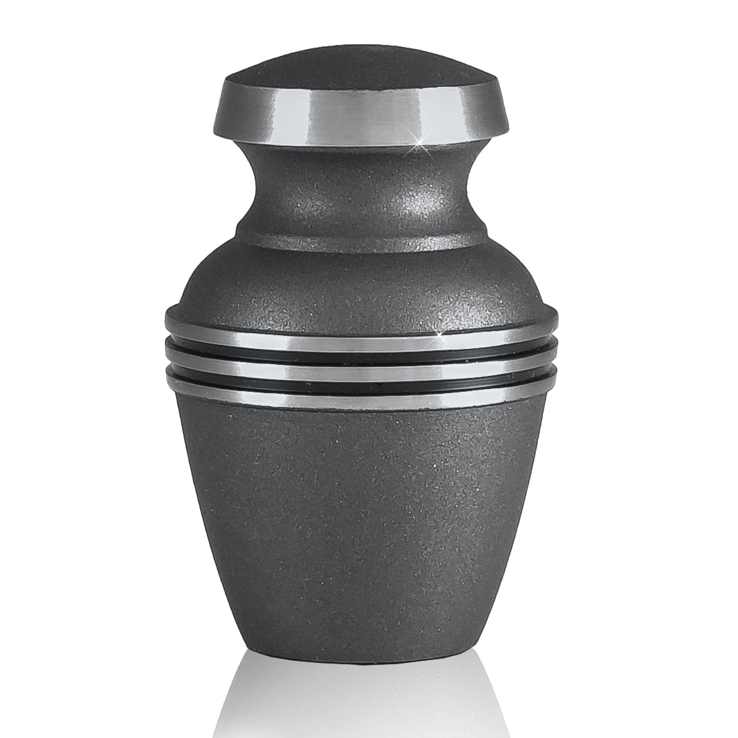 Plain polished brass keepsake urn with tapered body and a domed lid