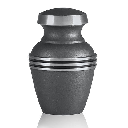 Plain polished brass keepsake urn with tapered body and a domed lid