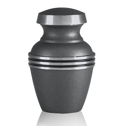 Plain polished brass keepsake urn with tapered body and a domed lid