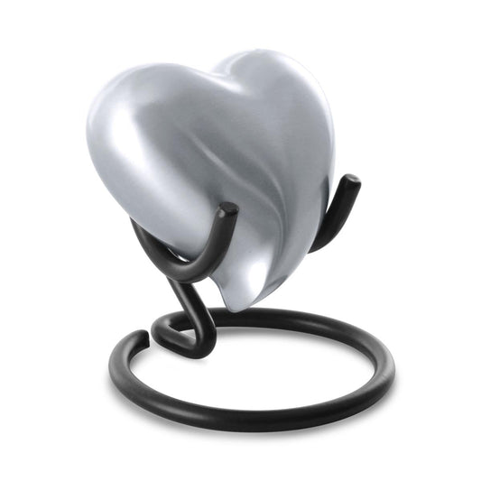 Heart-shaped keepsake urn in a soft grey pewter finish over brass, smooth and unadorned
