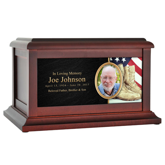 Wooden cremation urn printed with worn combat boots standing before an American flag