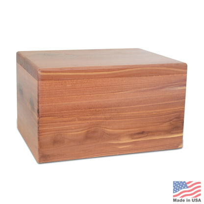 Low rectangular cedar cremation urn with reddish grain and clean unadorned edges