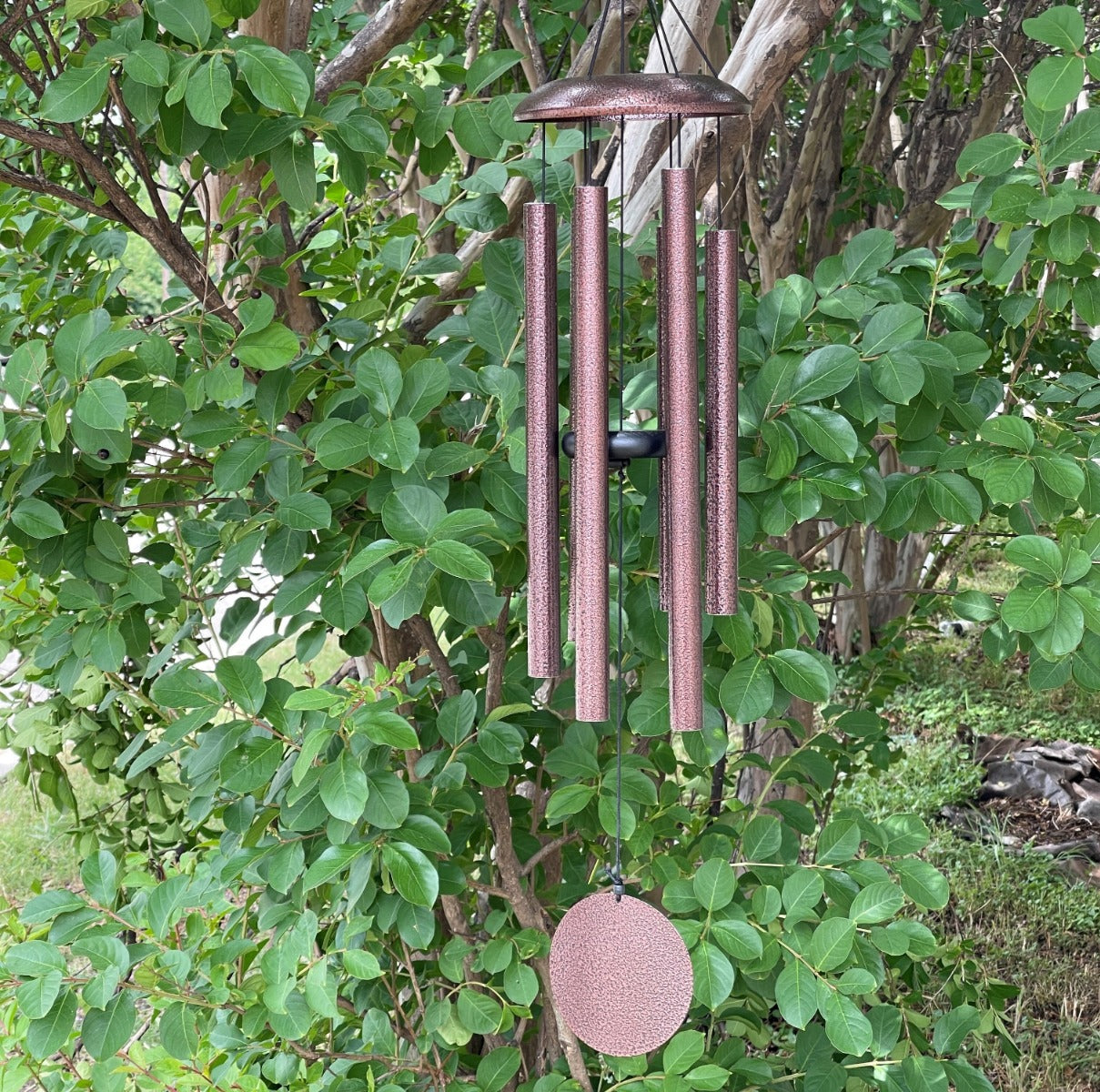 Memorial windchime with a cluster of metal tubes and a keepsake chamber at the top